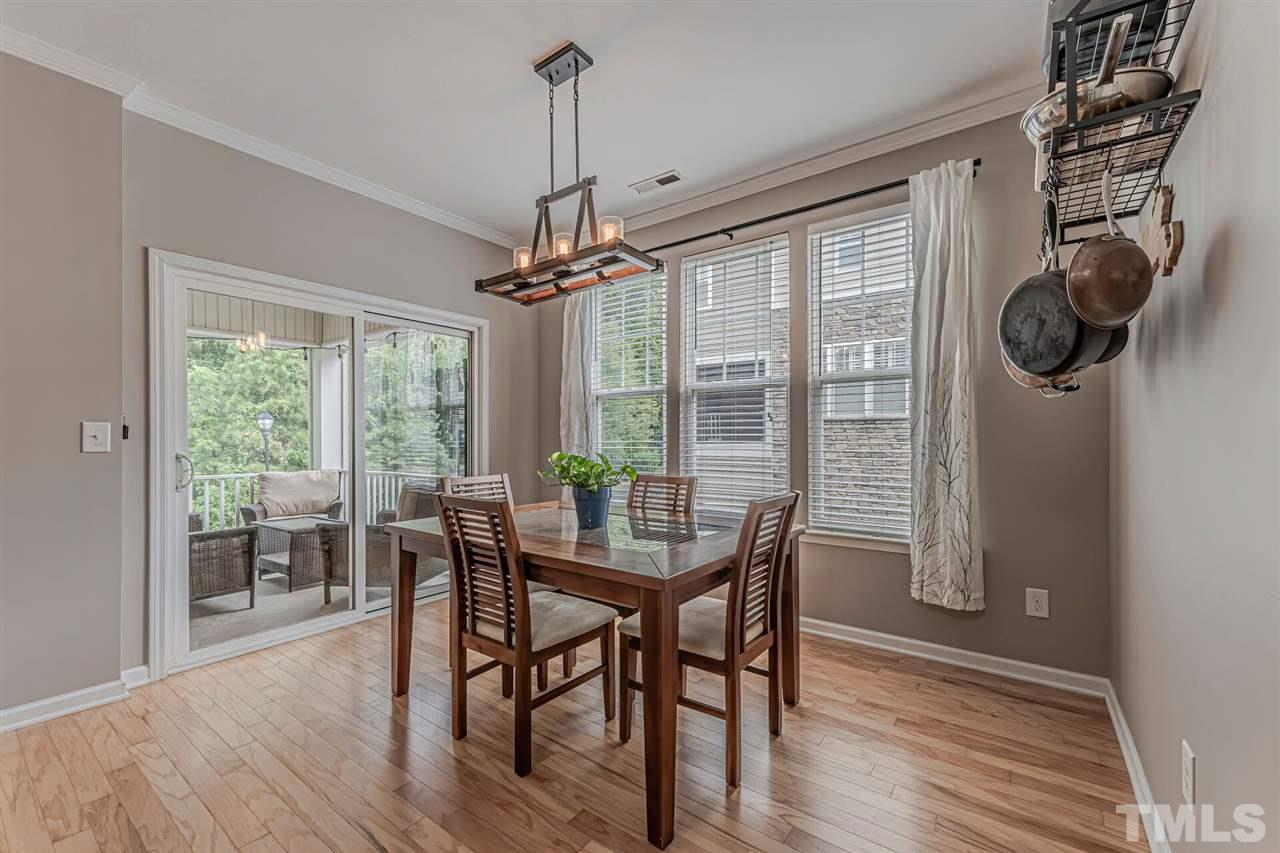 5903 Hourglass Court Raleigh, NC 27612 - Photo 13 of 29 a view of a dining room with furniture window and wooden floor