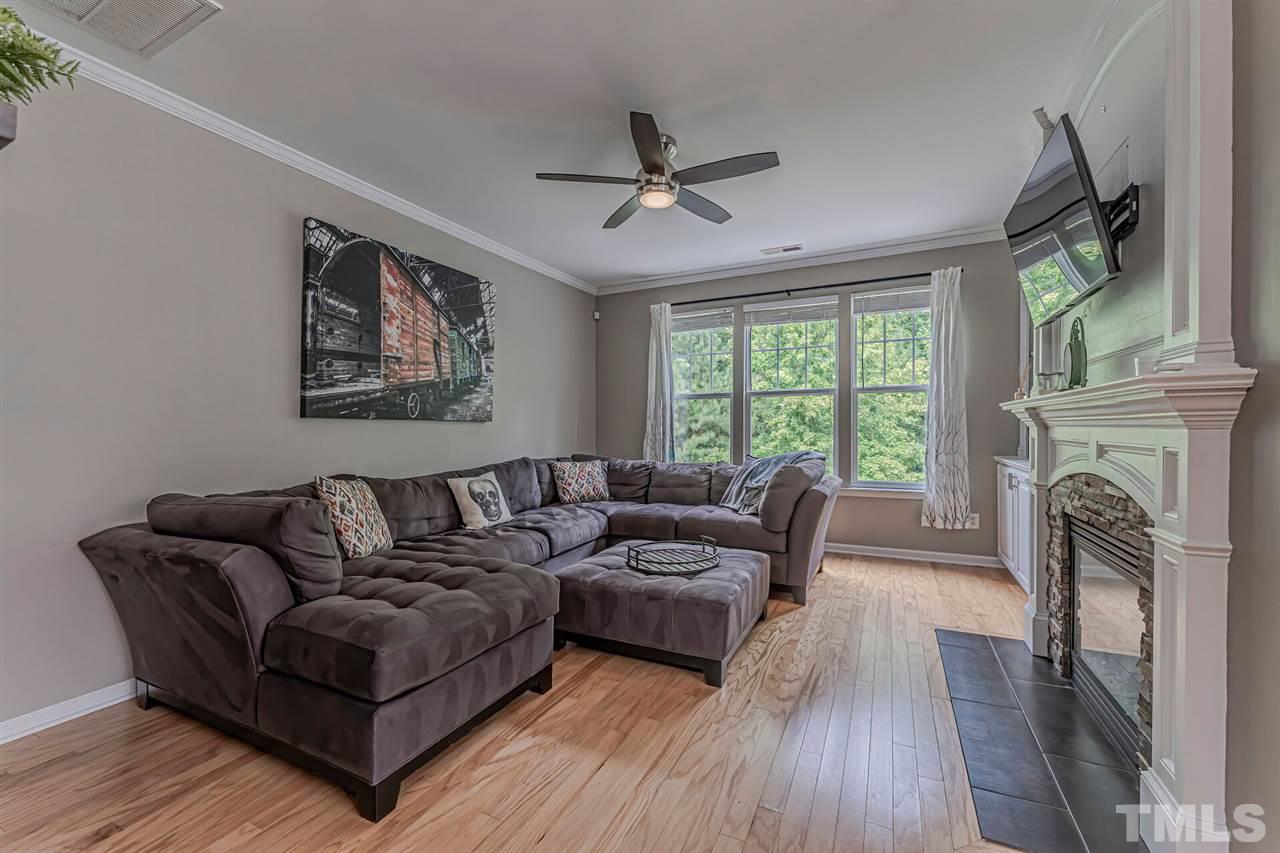5903 Hourglass Court Raleigh, NC 27612 - Photo 15 of 29 a living room with furniture and a fireplace