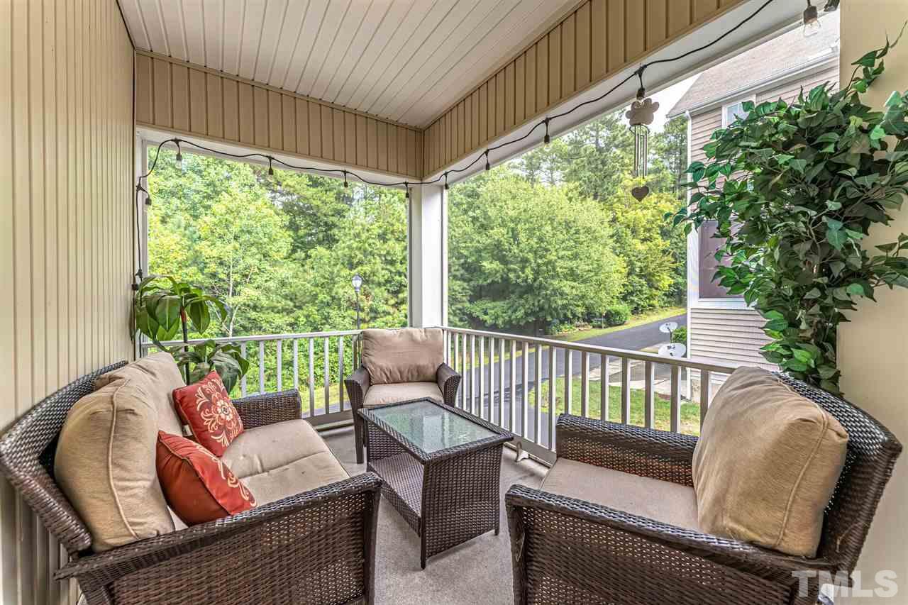 5903 Hourglass Court Raleigh, NC 27612 - Photo 17 of 29 a balcony with wooden floor and outdoor seating