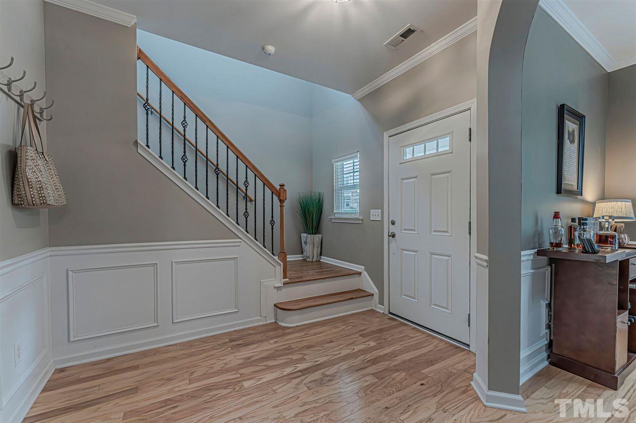 5903 Hourglass Court Raleigh, NC 27612 - Photo 3 of 29 a view of a hallway with wooden floor and staircase