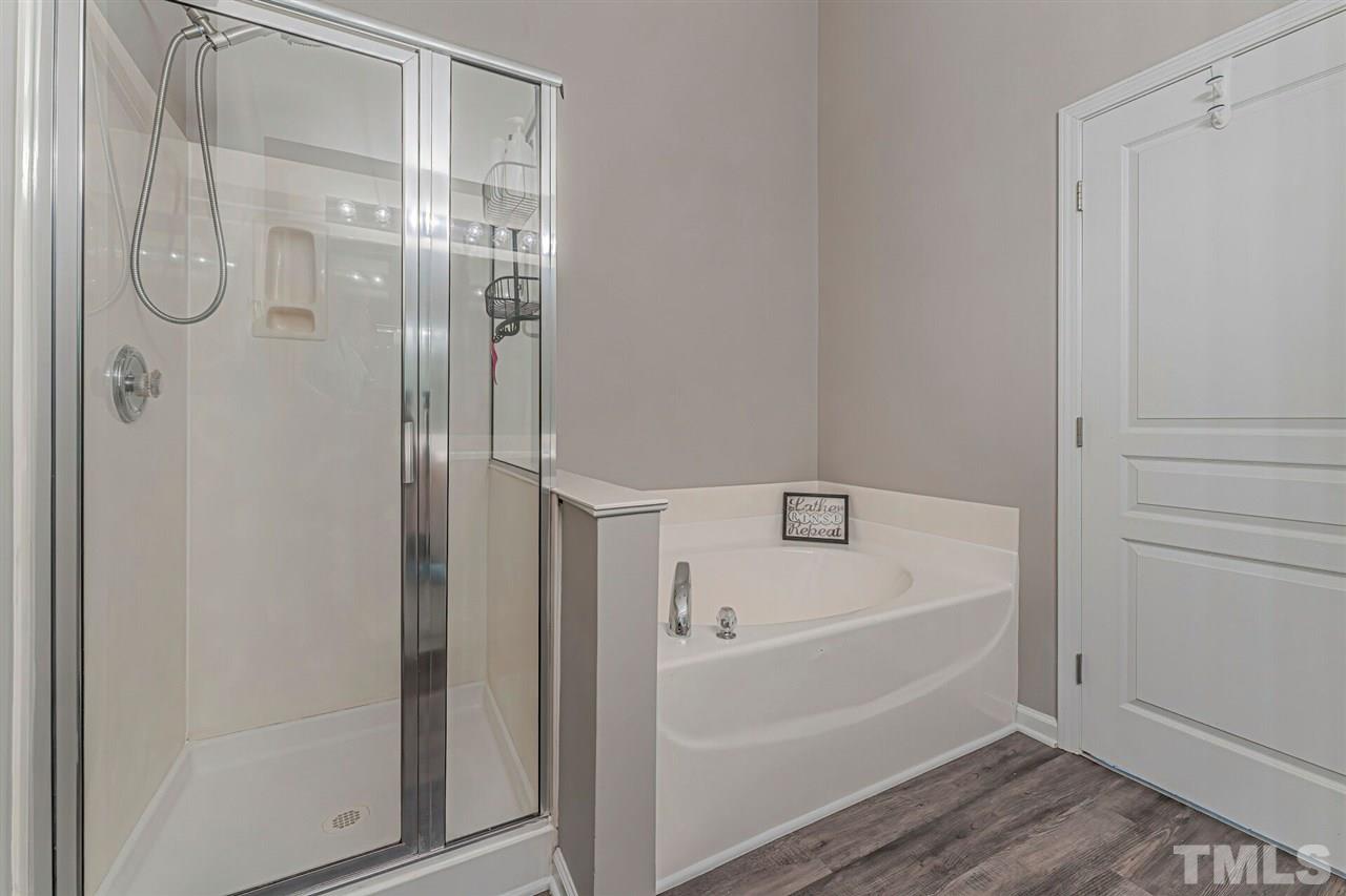 5903 Hourglass Court Raleigh, NC 27612 - Photo 21 of 29 a bathroom with a bathtub and a shower