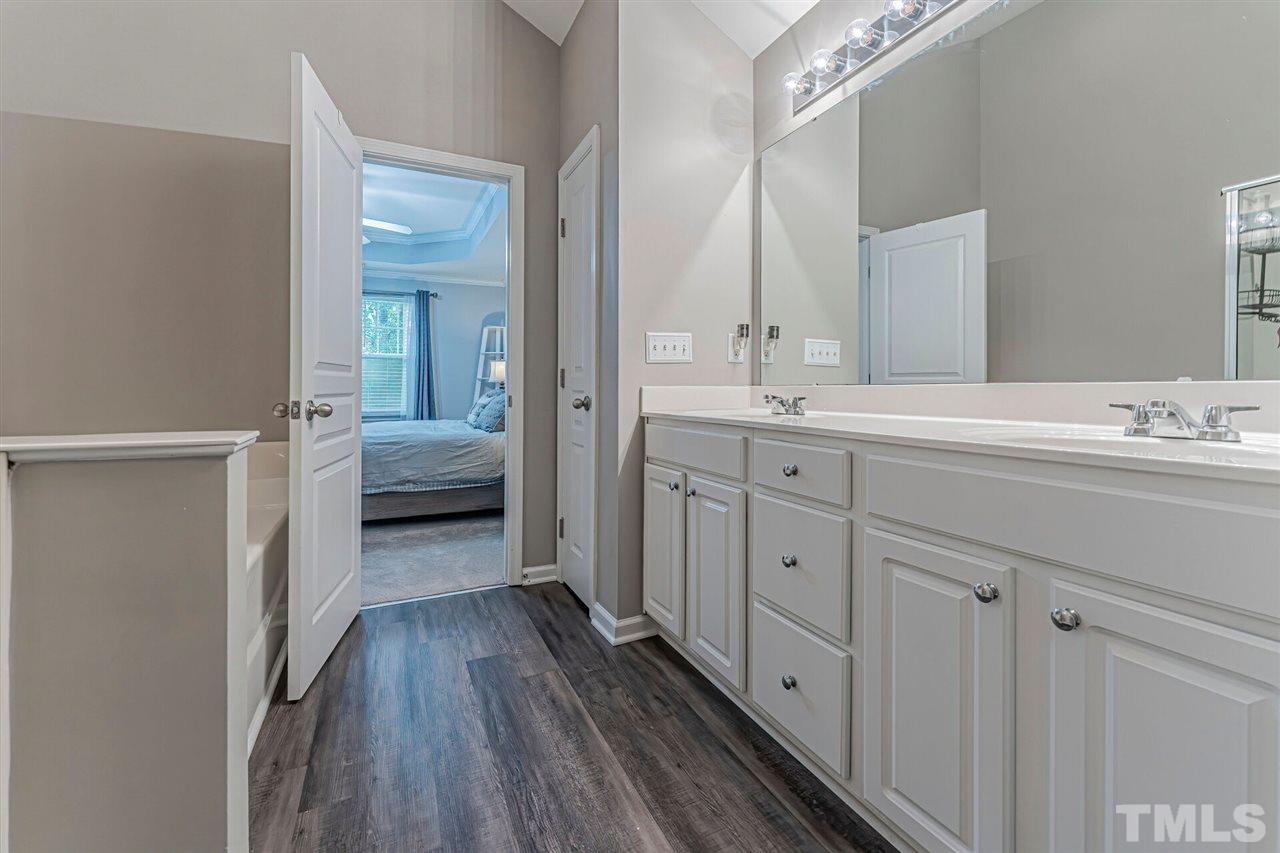 5903 Hourglass Court Raleigh, NC 27612 - Photo 22 of 29 a spacious bathroom with a double vanity sink and mirror