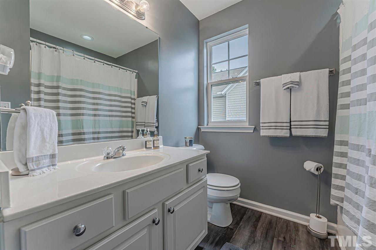 5903 Hourglass Court Raleigh, NC 27612 - Photo 25 of 29 a bathroom with a sink toilet and shower