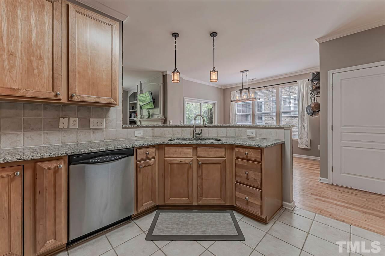 5903 Hourglass Court Raleigh, NC 27612 - Photo 10 of 29 a kitchen with stainless steel appliances granite countertop cabinets and window