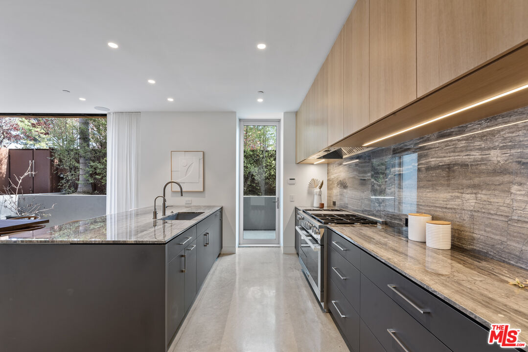 1601 Shell Avenue Venice, CA 90291 - Photo 18 of 61 a kitchen with stainless steel appliances granite countertop a sink stove and cabinets