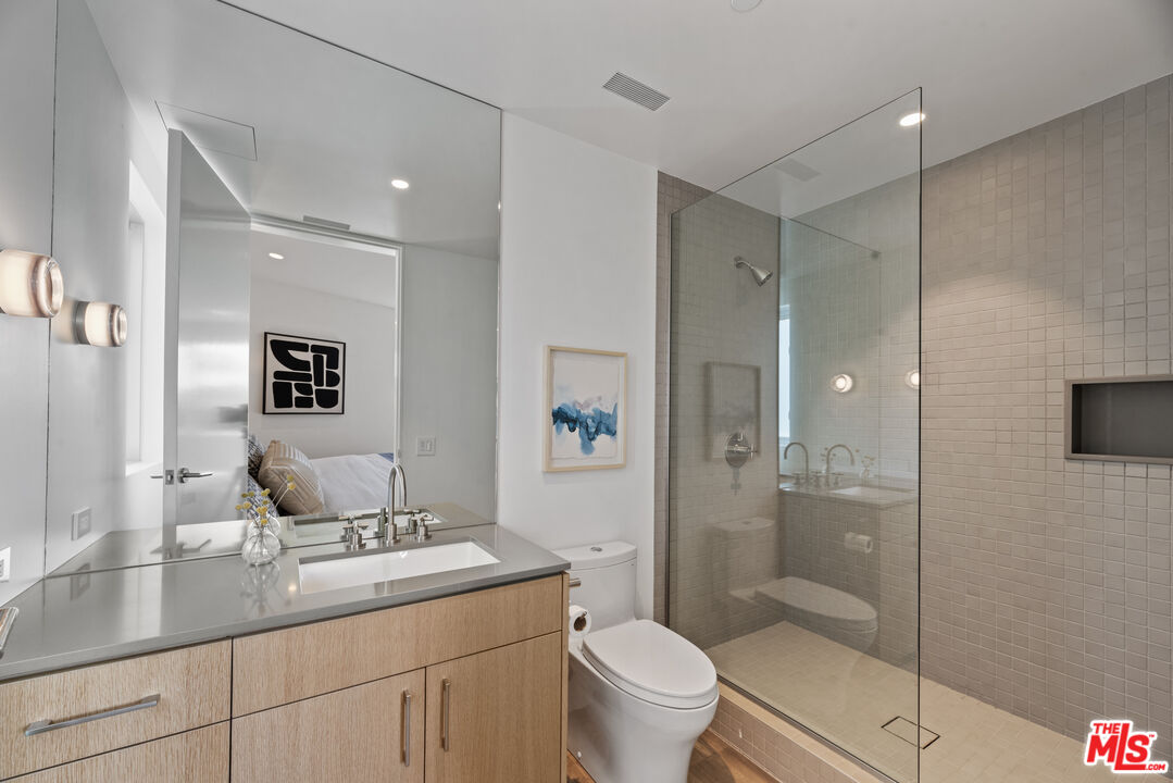 1601 Shell Avenue Venice, CA 90291 - Photo 50 of 61 a bathroom with a granite countertop sink a toilet a mirror and shower