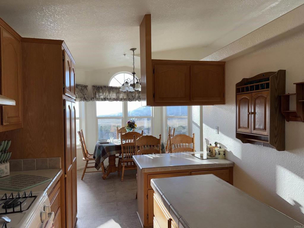 37697 Montezuma Valley Road Ranchita, CA 92066 - Photo 18 of 47 a kitchen with sink refrigerator and microwave