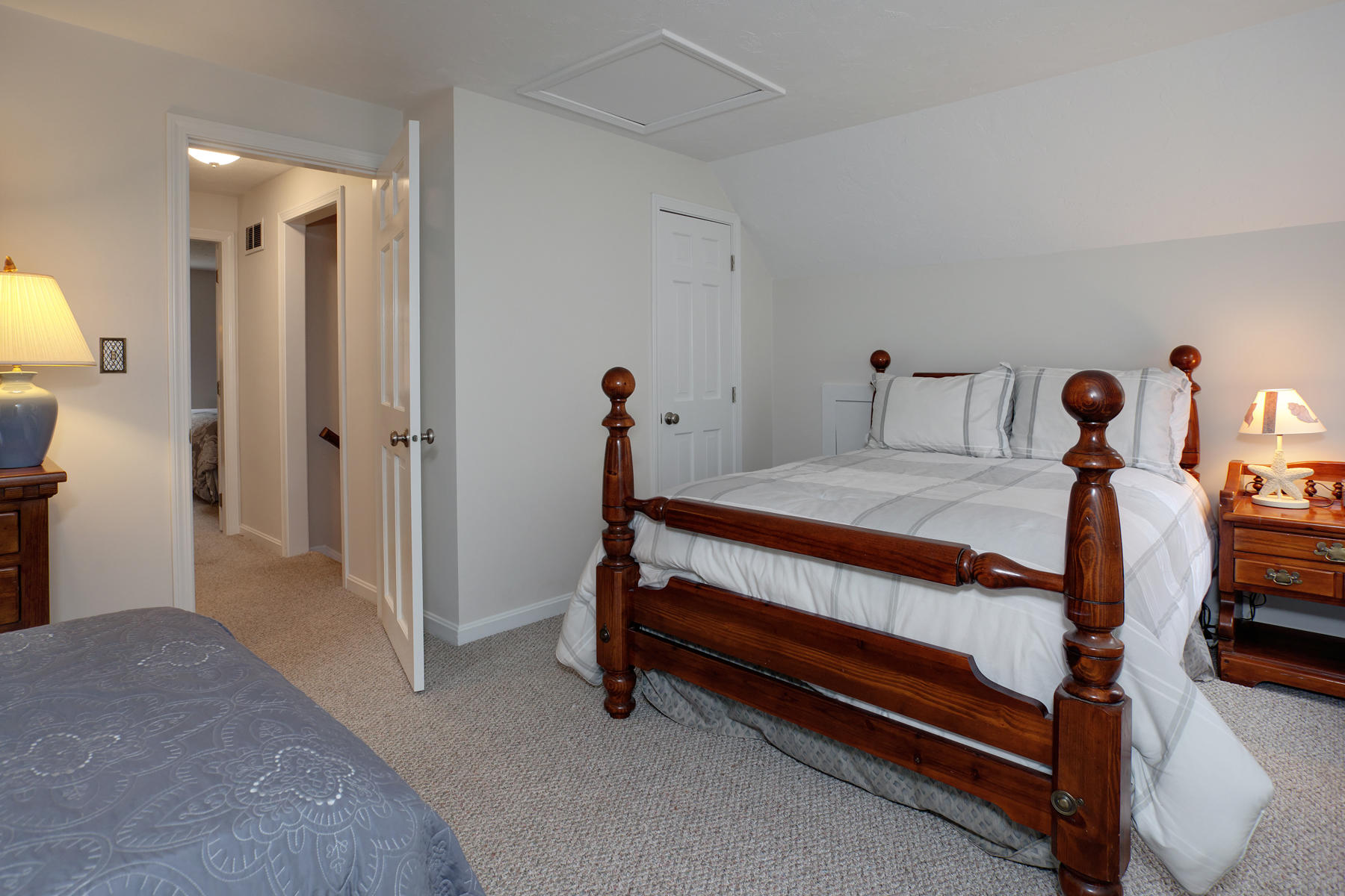2 Timberknoll Road Pocasset, MA 02559 - Photo 16 of 26 a bedroom with a bed and a chandelier