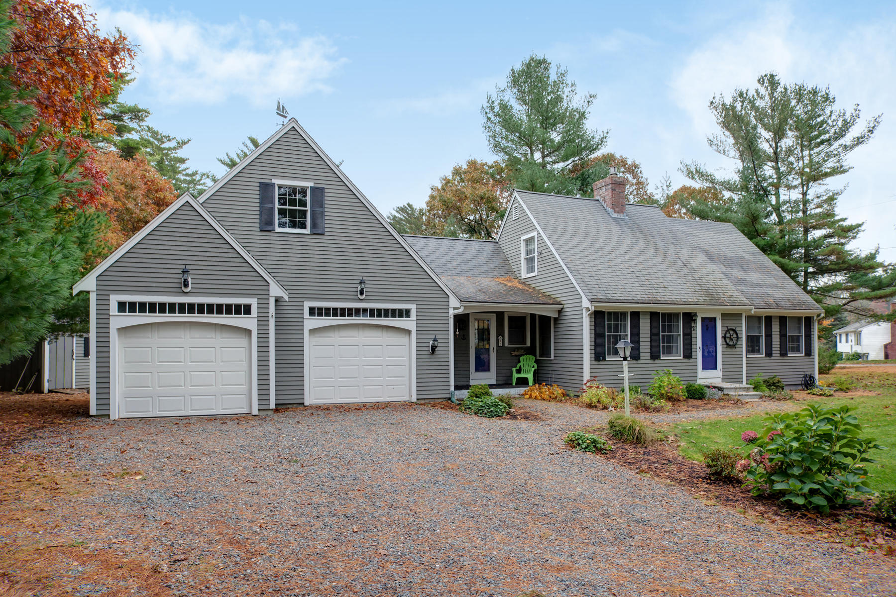 2 Timberknoll Road Pocasset, MA 02559 - Photo 26 of 26 a front view of a house with a yard and potted plants