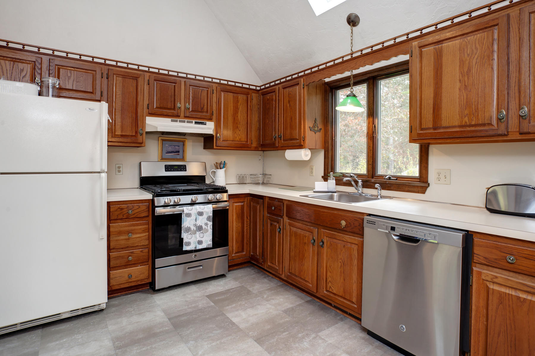 2 Timberknoll Road Pocasset, MA 02559 - Photo 3 of 26 a kitchen with stainless steel appliances granite countertop a refrigerator sink and cabinets