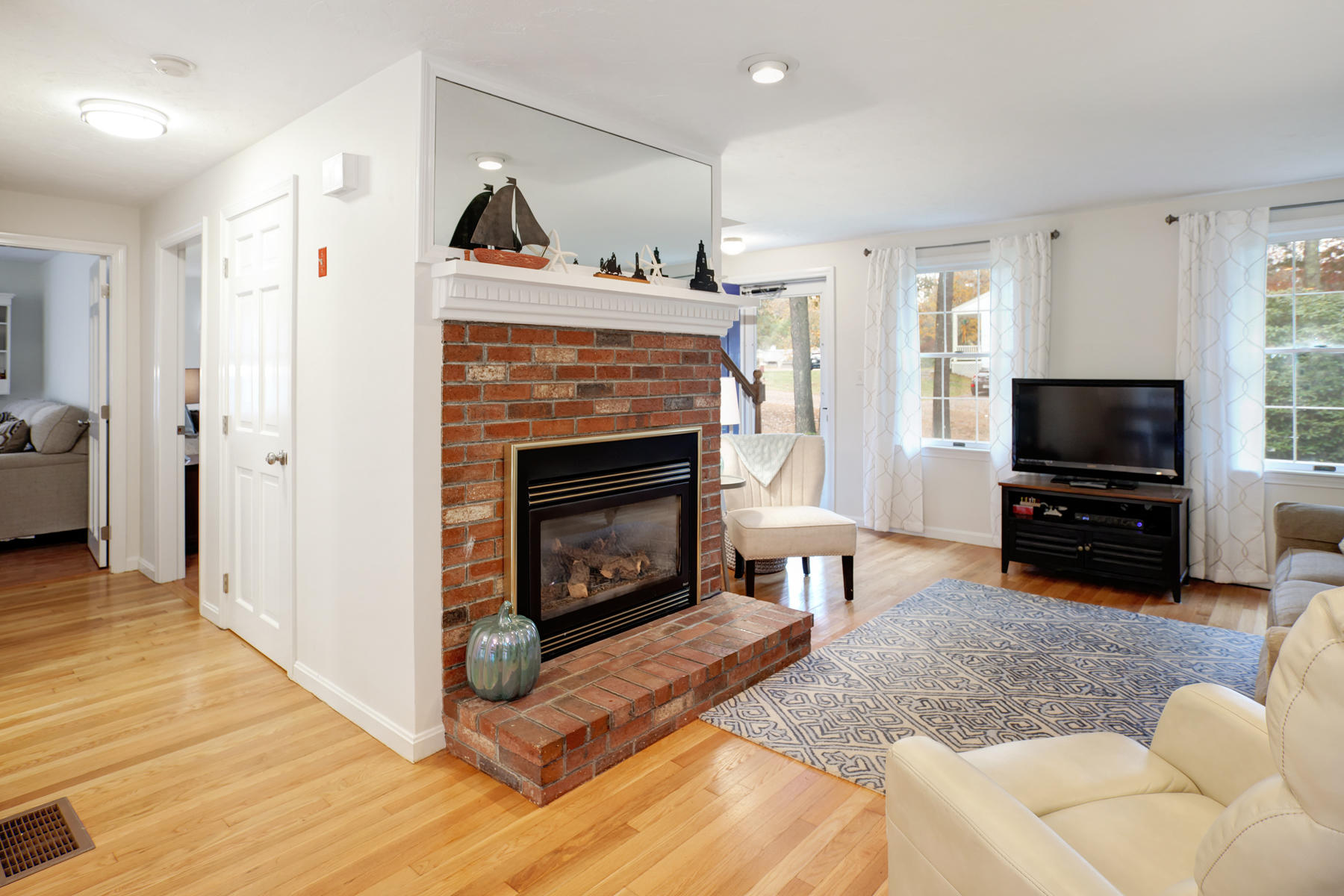 2 Timberknoll Road Pocasset, MA 02559 - Photo 9 of 26 a living room with furniture and a fireplace