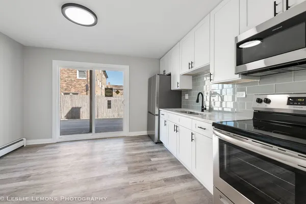 a kitchen with granite countertop a stove and a sink