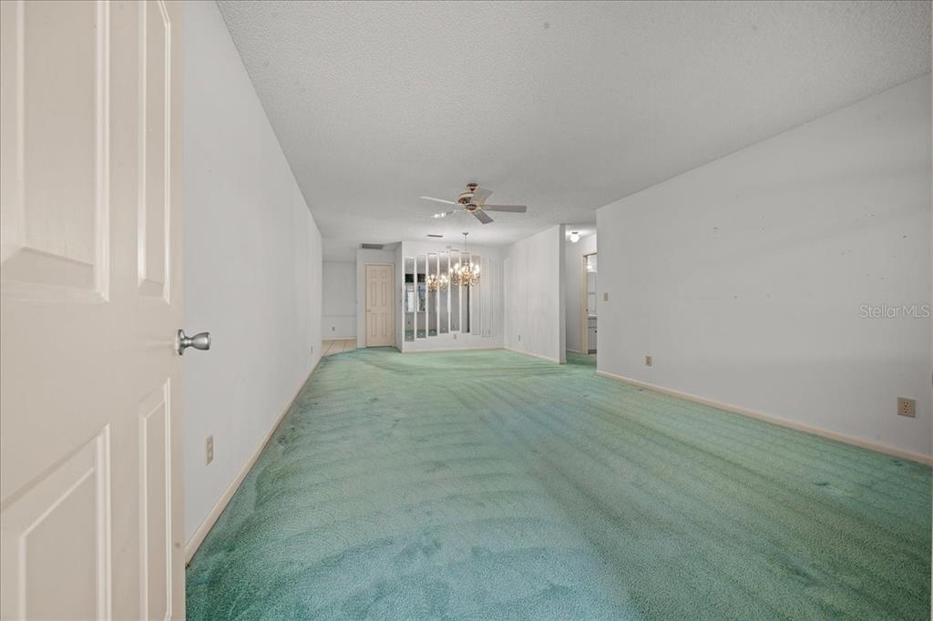 9377 Southwest 90th Court, Unit E Ocala, FL 34481 - Photo 11 of 77 a view of a hallway with chandelier and entryway
