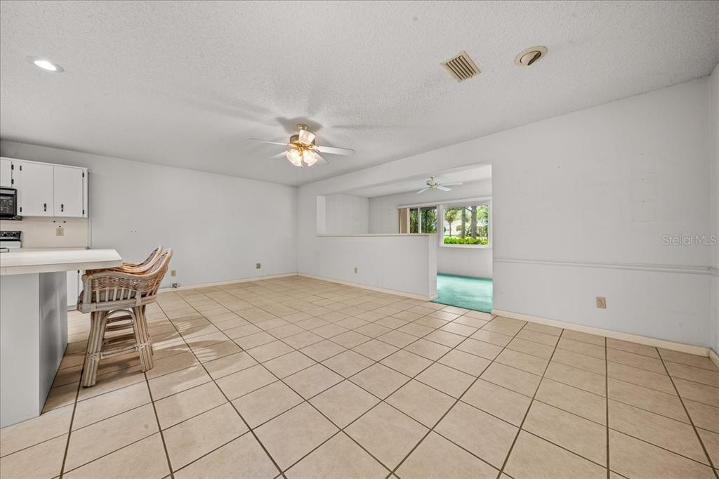 9377 Southwest 90th Court, Unit E Ocala, FL 34481 - Photo 25 of 77 a view of a livingroom with furniture and chandelier fan