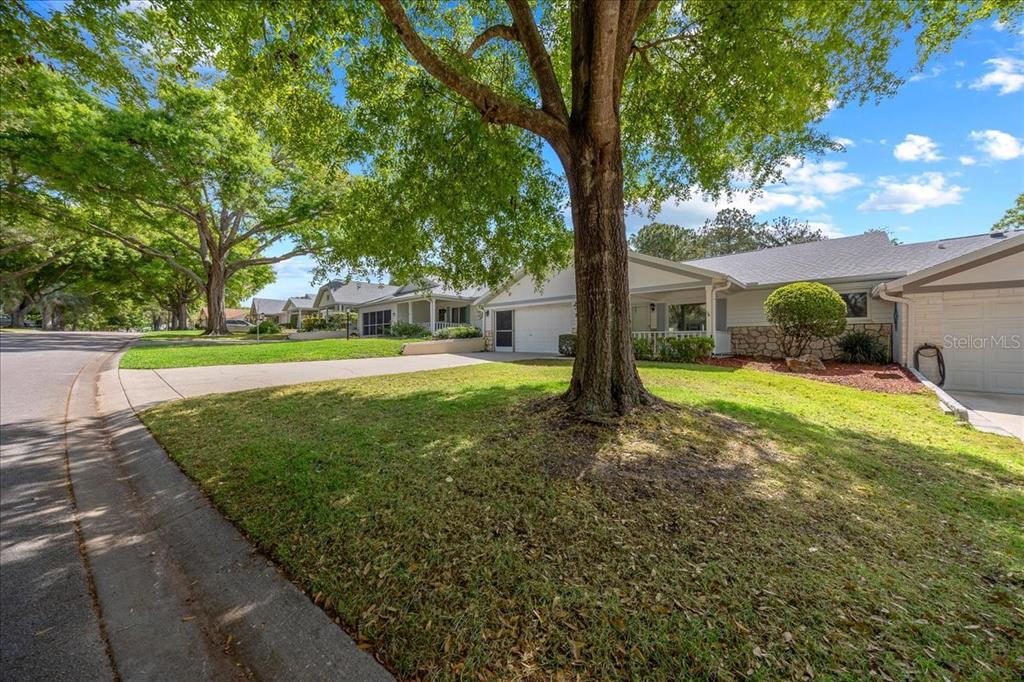9377 Southwest 90th Court, Unit E Ocala, FL 34481 - Photo 3 of 77 a view of a house with a yard and tree s