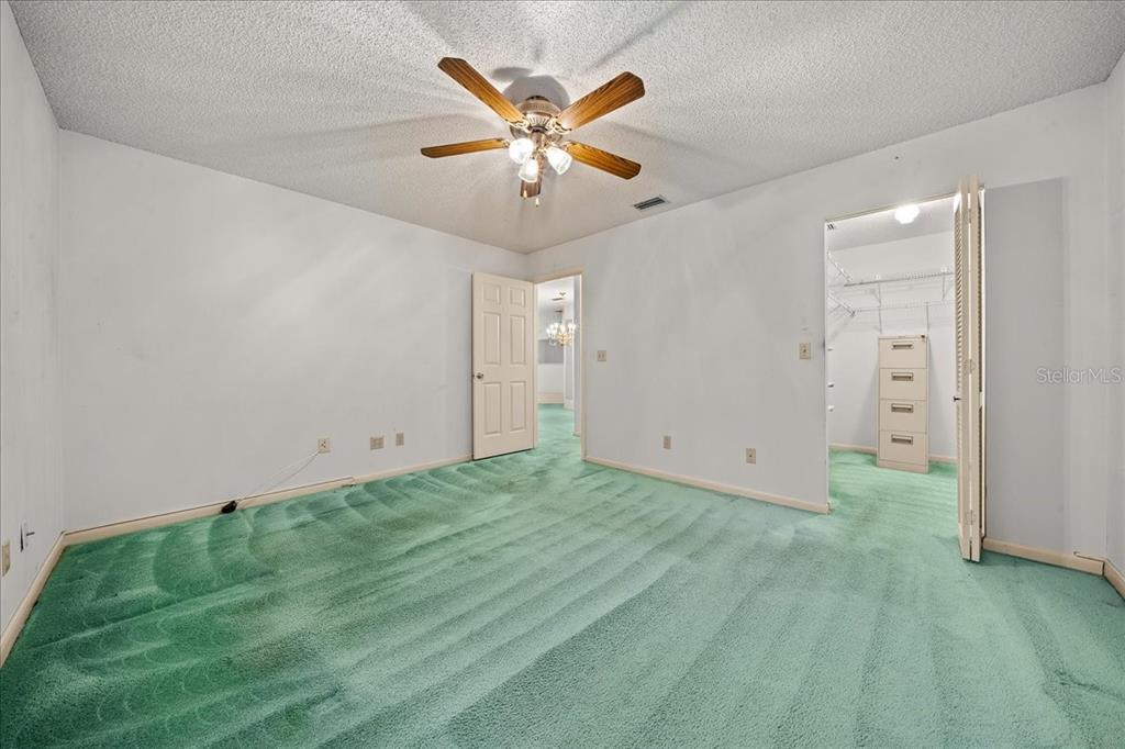 9377 Southwest 90th Court, Unit E Ocala, FL 34481 - Photo 32 of 77 an empty room with closet and ceiling fan