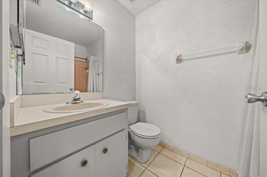 9377 Southwest 90th Court, Unit E Ocala, FL 34481 - Photo 35 of 77 a bathroom with a sink toilet and mirror