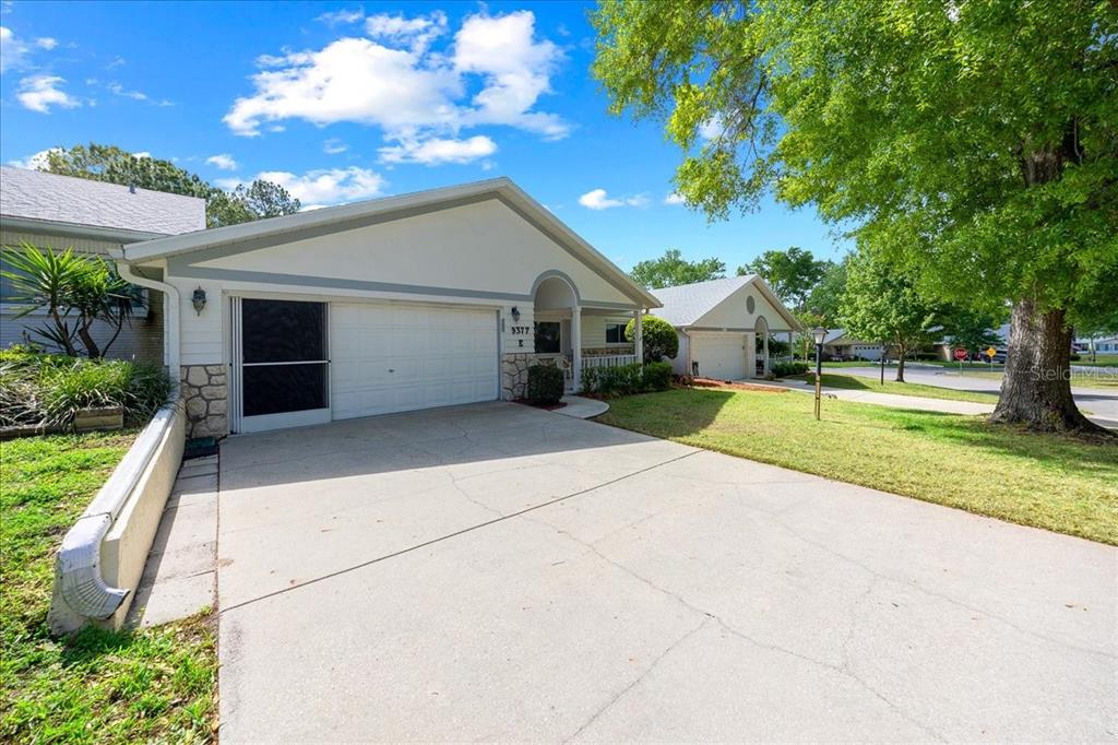 9377 Southwest 90th Court, Unit E Ocala, FL 34481 - Photo 4 of 77 a house view with a garden space