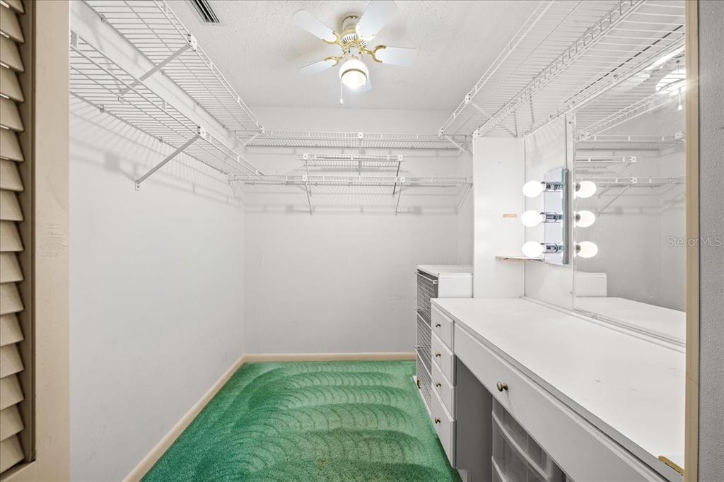 9377 Southwest 90th Court, Unit E Ocala, FL 34481 - Photo 41 of 77 a bathroom with a sink and a chandelier