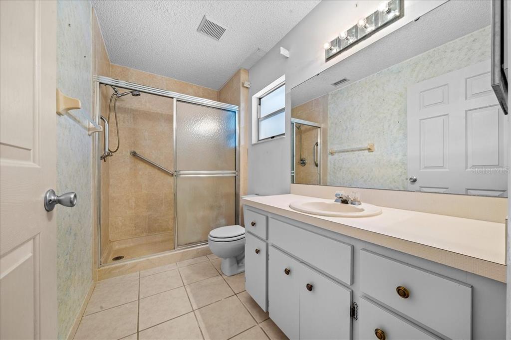 9377 Southwest 90th Court, Unit E Ocala, FL 34481 - Photo 44 of 77 a bathroom with a sink a toilet and shower