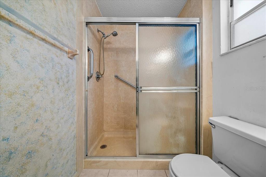 9377 Southwest 90th Court, Unit E Ocala, FL 34481 - Photo 45 of 77 a bathroom with a shower and a toilet