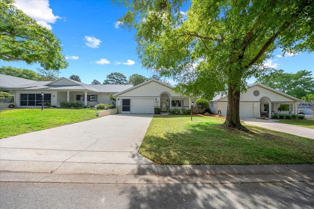 9377 Southwest 90th Court, Unit E Ocala, FL 34481 - Photo 5 of 77 a front view of a house with a yard