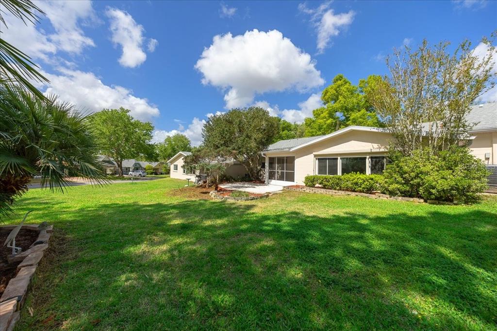 9377 Southwest 90th Court, Unit E Ocala, FL 34481 - Photo 51 of 77 a front view of a house with garden
