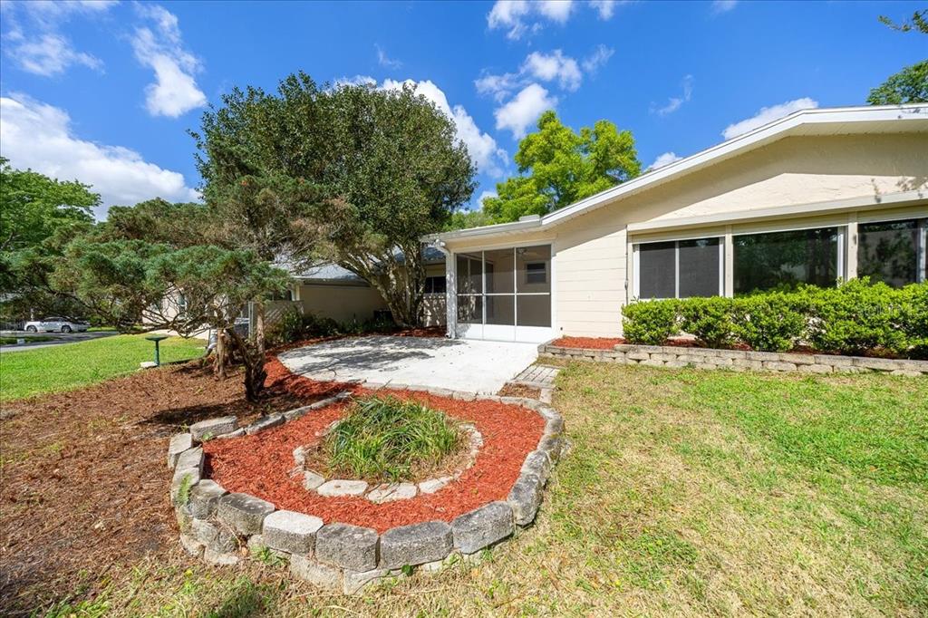 9377 Southwest 90th Court, Unit E Ocala, FL 34481 - Photo 53 of 77 a view of a house with backyard and sitting area