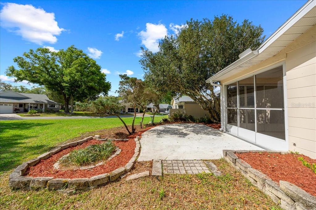 9377 Southwest 90th Court, Unit E Ocala, FL 34481 - Photo 54 of 77 a view of a backyard with a garden and plants