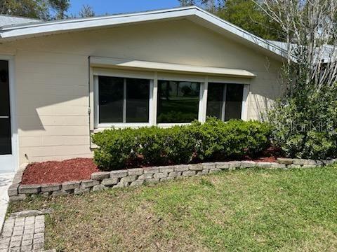 9377 Southwest 90th Court, Unit E Ocala, FL 34481 - Photo 61 of 77 a front view of a house with a yard