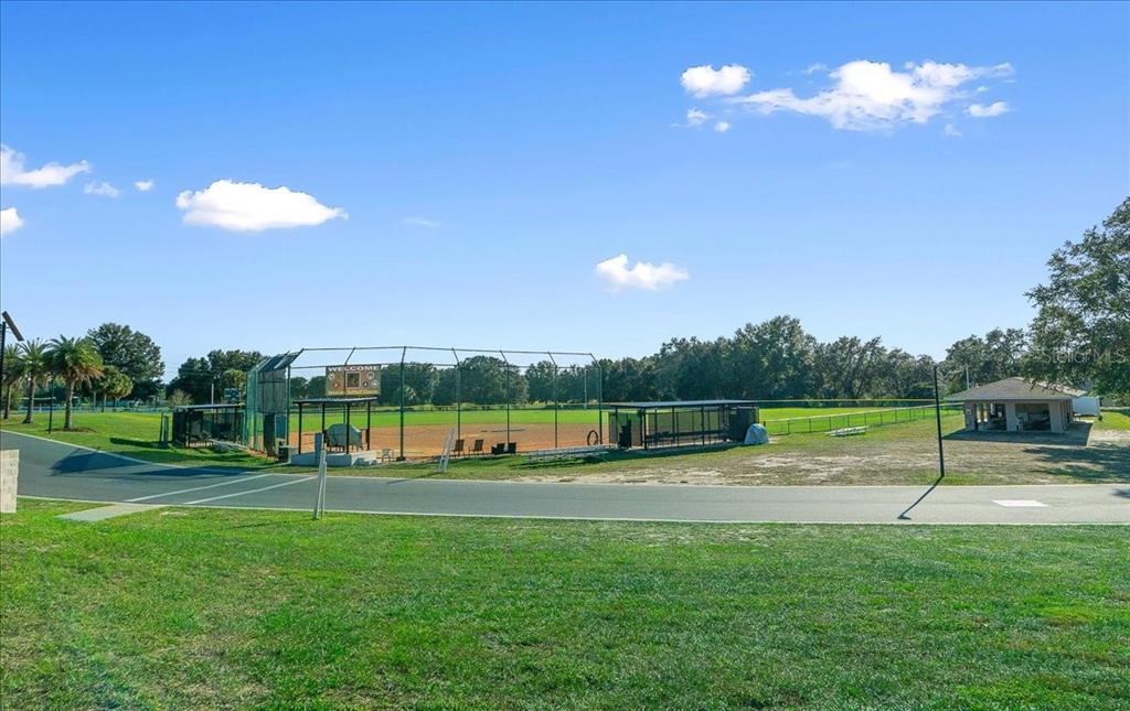9377 Southwest 90th Court, Unit E Ocala, FL 34481 - Photo 70 of 77 a view of a golf course with a lake