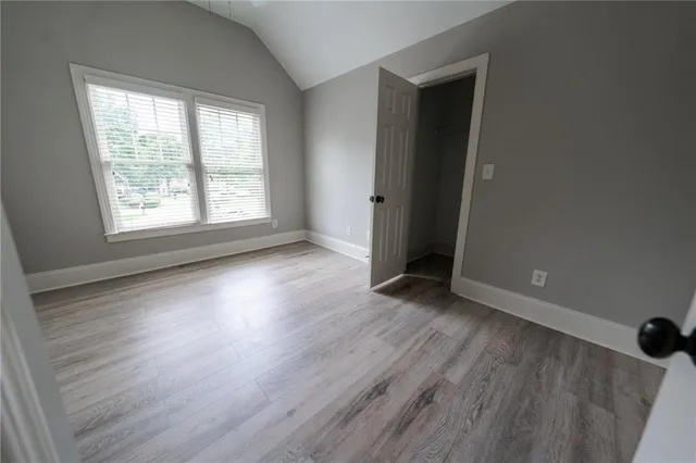 a view of entryway and hall with wooden floor