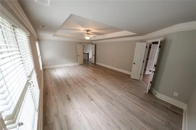 a view of a hallway view with wooden floor and staircase