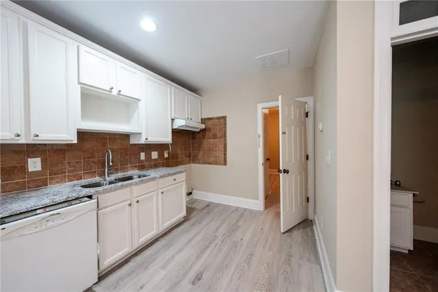 a view of a room with wooden floor