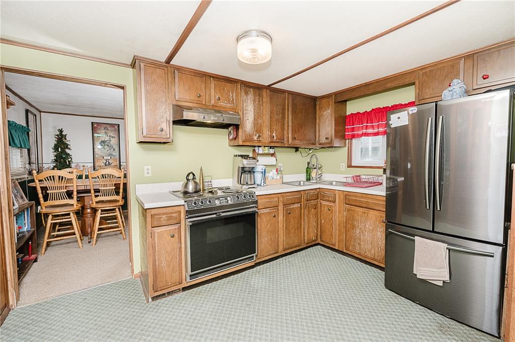 478 Exton Lake Road Apollo, PA 15613 - Photo 3 of 25 a kitchen with stainless steel appliances granite countertop a stove refrigerator sink and cabinets