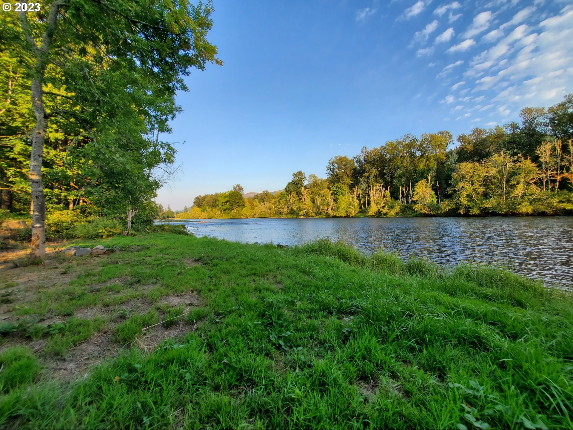 Mckenzie Highway Springfield, OR 97478 - Photo 22 of 29 a view of a lake with a building in the background