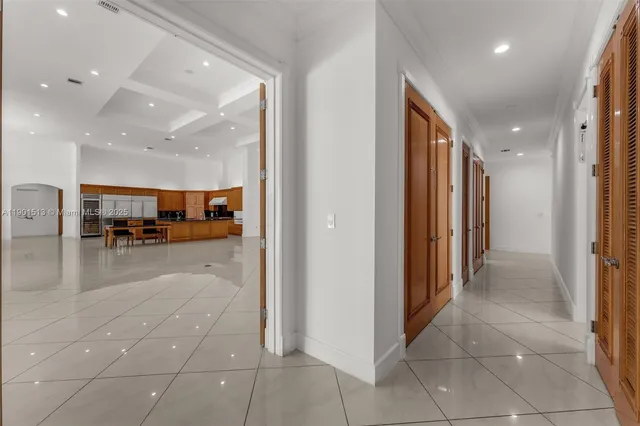 a kitchen with stainless steel appliances granite countertop a sink a stove a oven a counter space and living room view