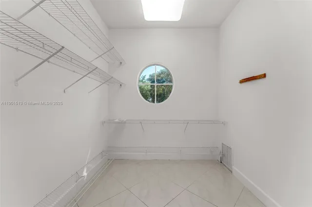an empty room with closet and fan