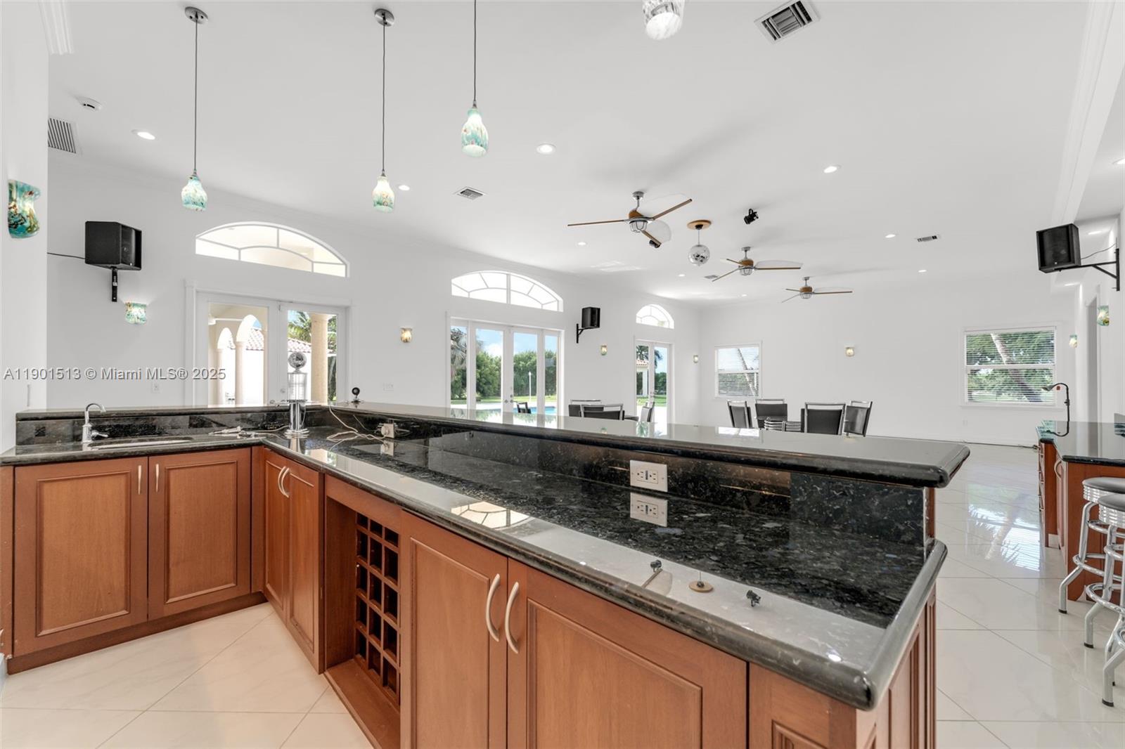 14950 Southwest 179th Avenue Miami, FL 33196 - Photo 26 of 55 a kitchen with stainless steel appliances granite countertop a sink a stove a oven a counter space and living room view