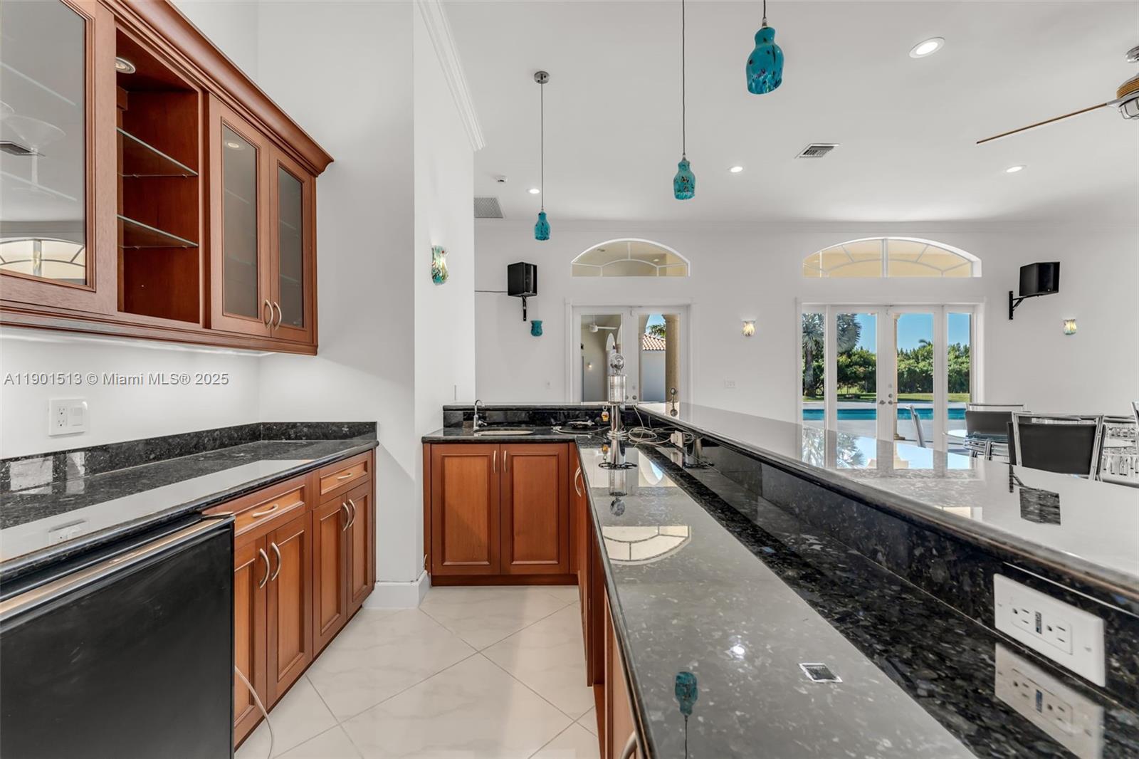 14950 Southwest 179th Avenue Miami, FL 33196 - Photo 27 of 55 a large kitchen with stainless steel appliances a large counter top a stove and a sink
