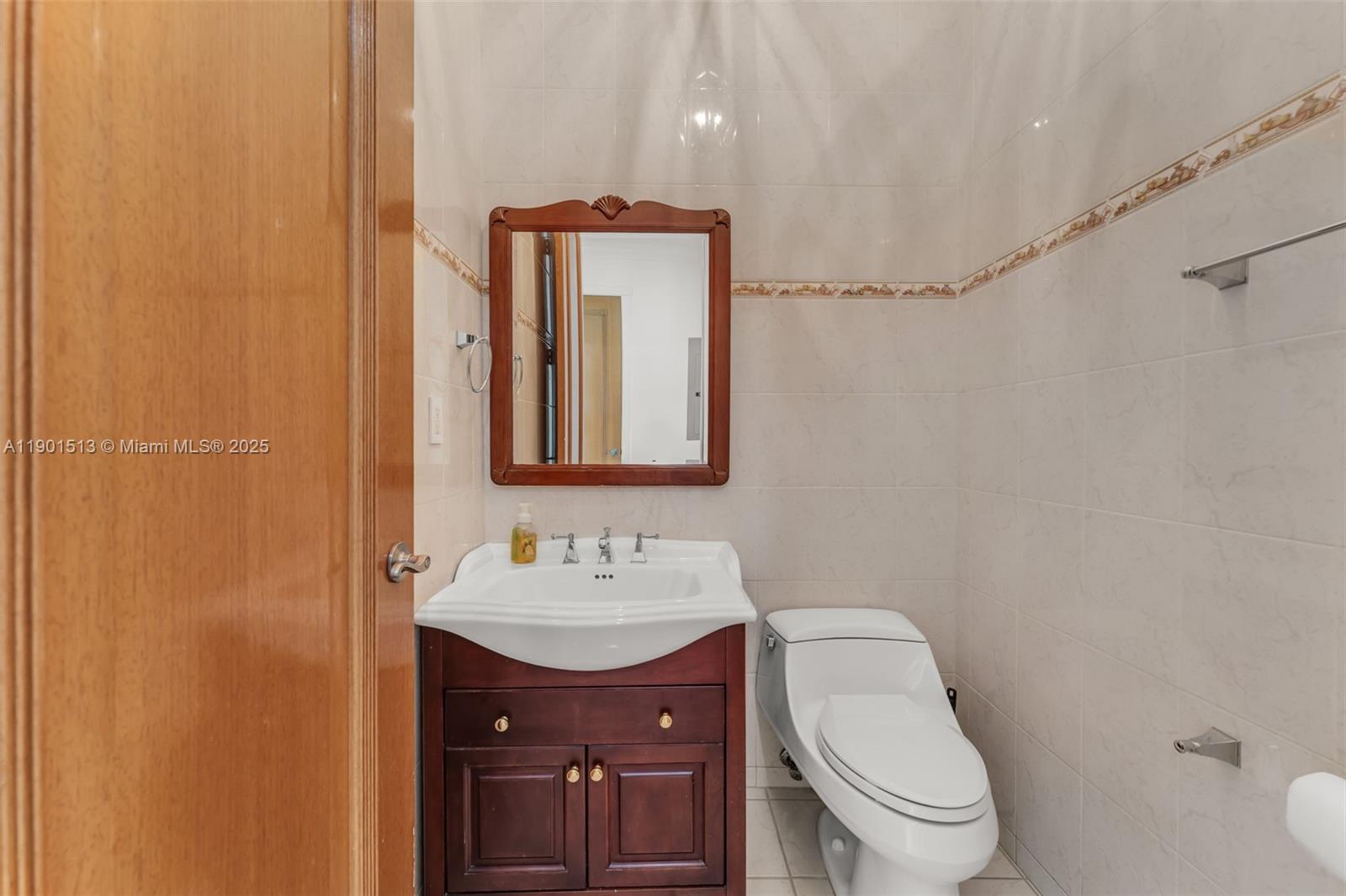 14950 Southwest 179th Avenue Miami, FL 33196 - Photo 29 of 55 a bathroom with a toilet a sink and mirror