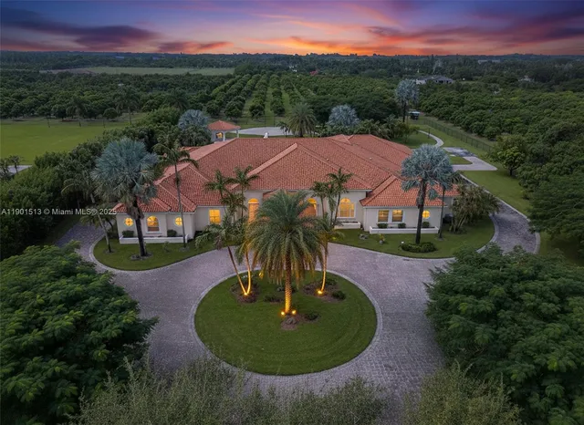 an aerial view of a house with outdoor space swimming pool and mountains