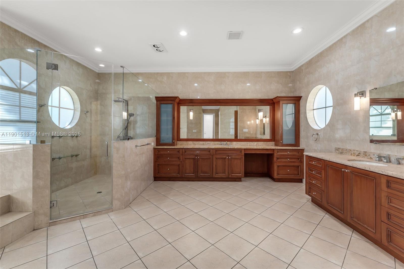 14950 Southwest 179th Avenue Miami, FL 33196 - Photo 33 of 55 a large bathroom with a large mirror vanity and a shower