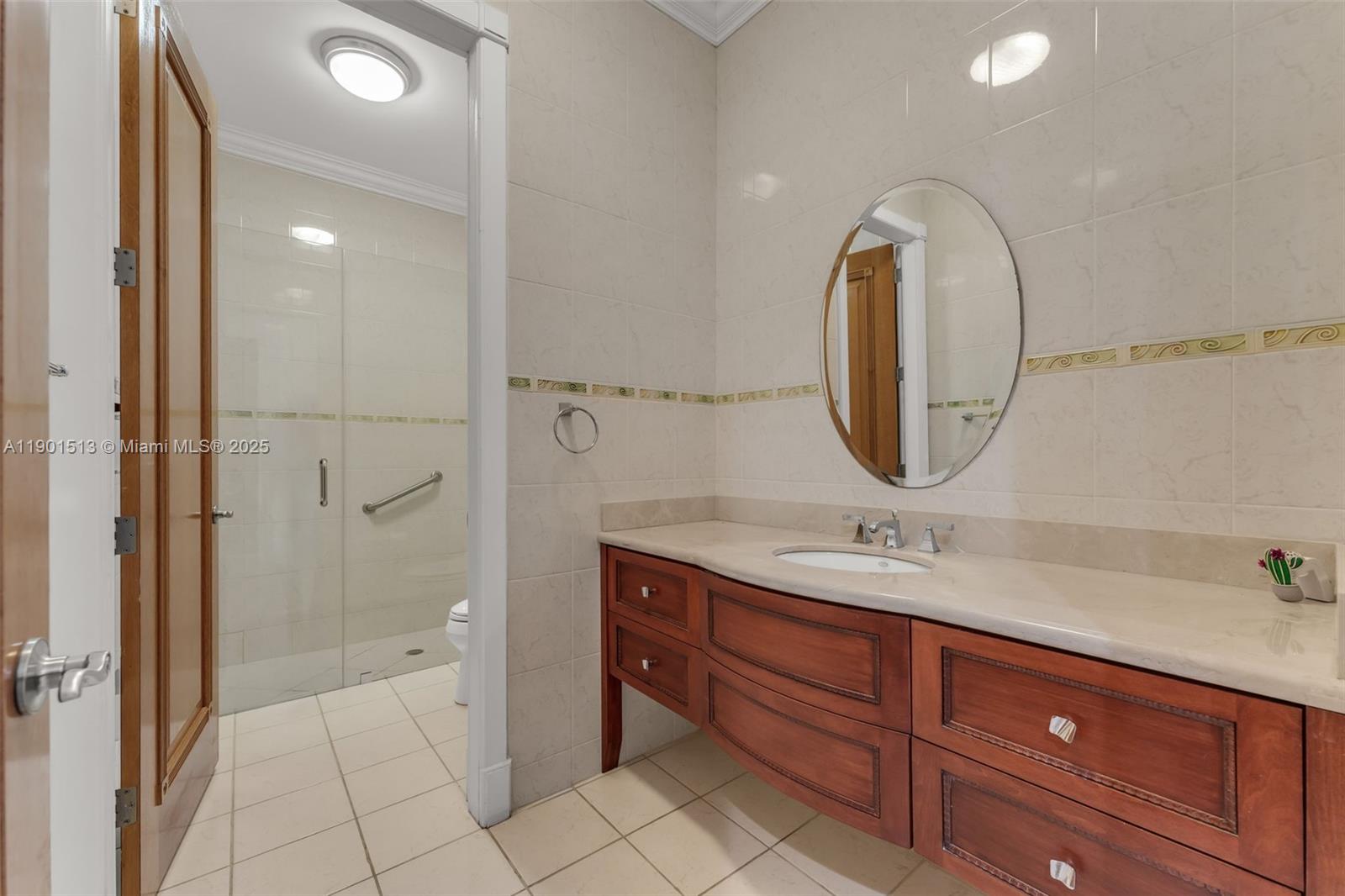 14950 Southwest 179th Avenue Miami, FL 33196 - Photo 36 of 55 a bathroom with a sink a vanity and a mirror