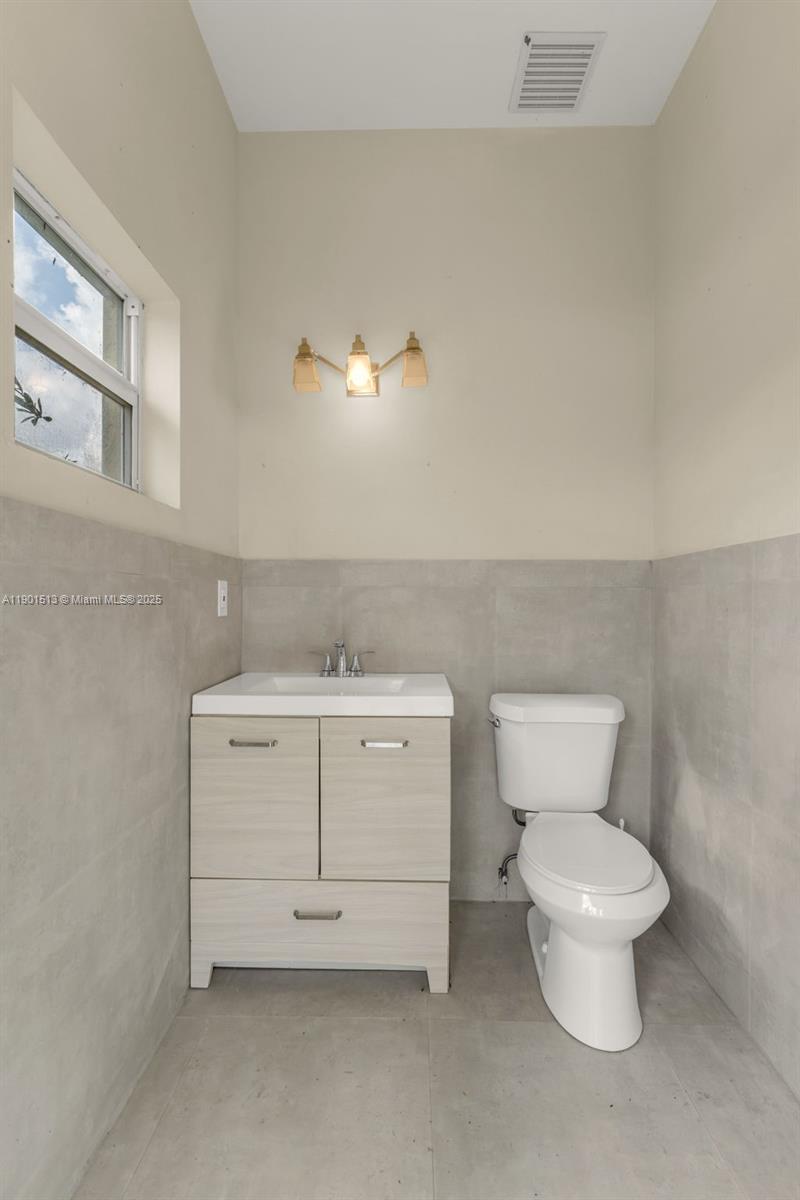 14950 Southwest 179th Avenue Miami, FL 33196 - Photo 48 of 55 a bathroom with a toilet sink and a mirror