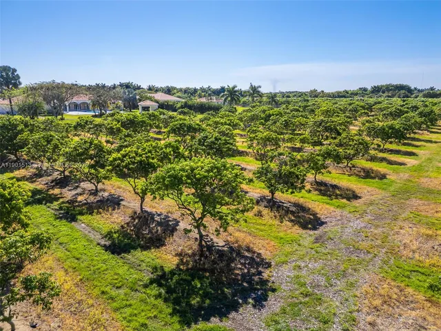 an aerial view of residential houses with yard