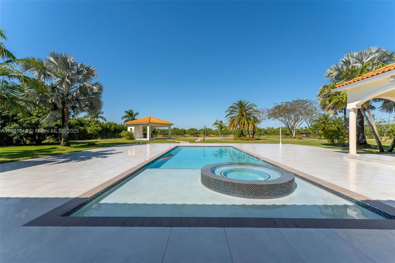 14950 Southwest 179th Avenue Miami, FL 33196 - Photo 9 of 55 a view of a swimming pool with a yard