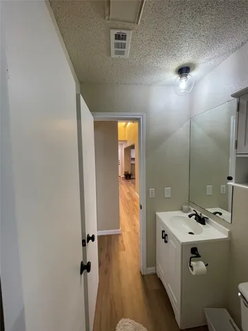 a bathroom with a sink mirror and toilet