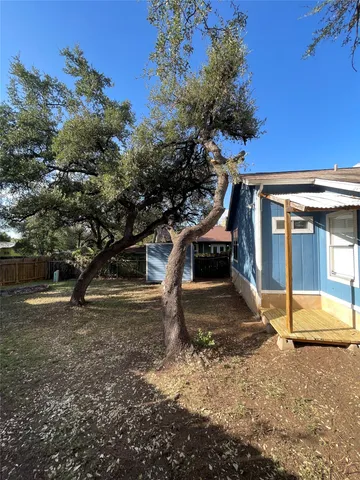 a view of a yard with a tree