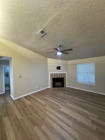 wooden floor in an empty room with a fireplace